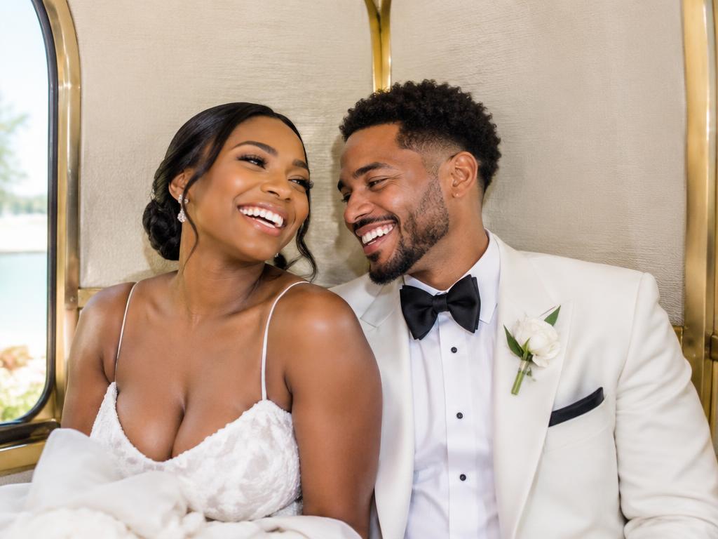 Bride and groom laughing together at their reception